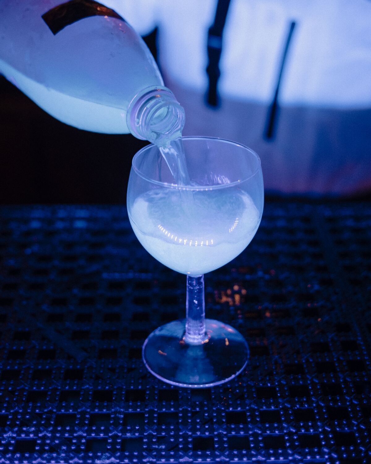 A glowing cocktail being poured