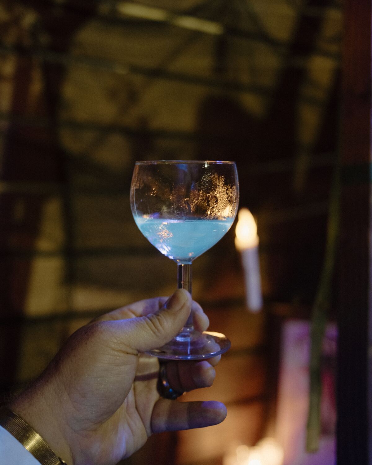 A glass held up to candlelight
